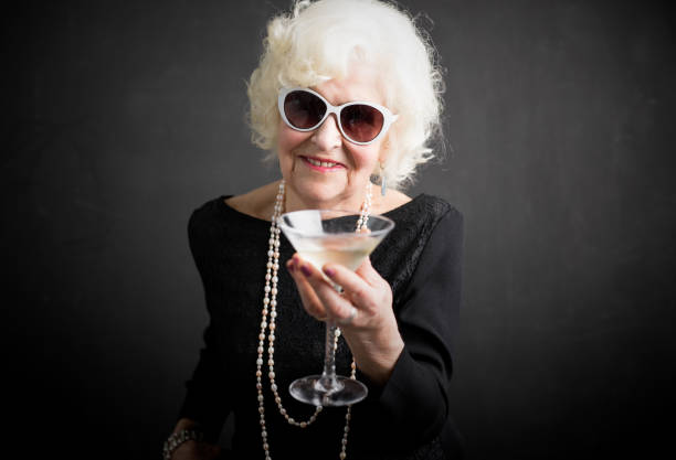 Cool grandma havinga a drink Cool grandma with sun glasses on havinga a drink grandma portrait stock pictures, royalty-free photos & images