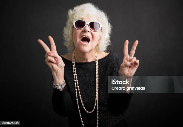 Cool Grandmother Showing Peace Sign Stock Photo - Download Image Now - Grandmother, Senior Adult, Senior Women