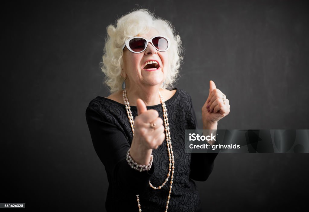 Cool grandma with her thumbs up Cool grandma with  both of her thumbs up Grandmother Stock Photo