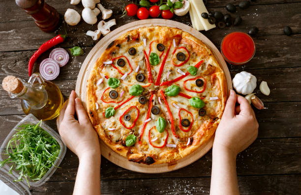 istock serve traditional tasty pizza on wooden table 664627110