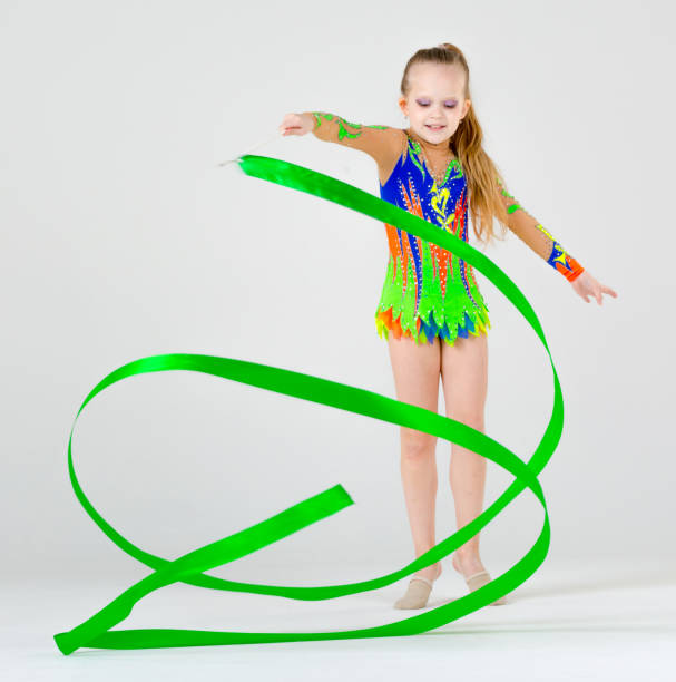 istock Cheerful Rhythmic Gymnast Shows Skills With Ribbon 664627496