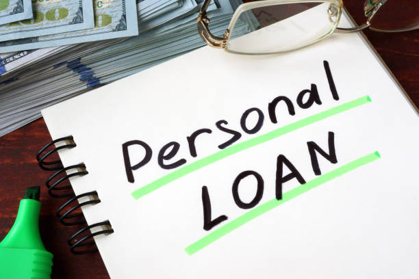 istock Personal Loan written on a notebook and dollars. 664627604