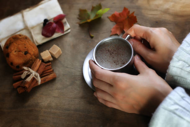 istock hands holding a mug of hot coffee on a table 664630512
