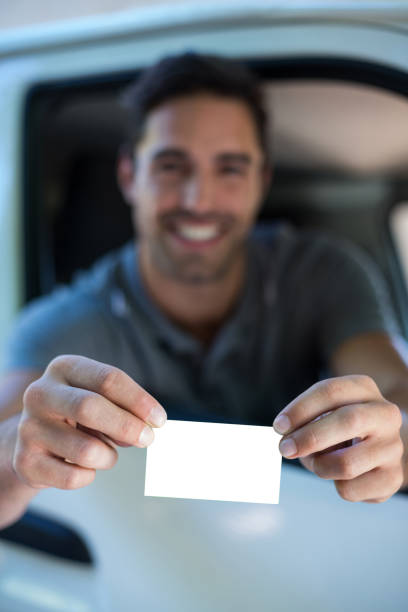 istock Handsome man showing business card 664631248