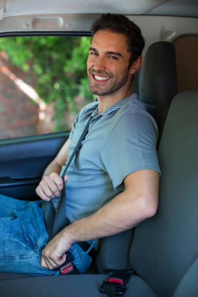 istock Handsome driver fastening car seat belt 664631548