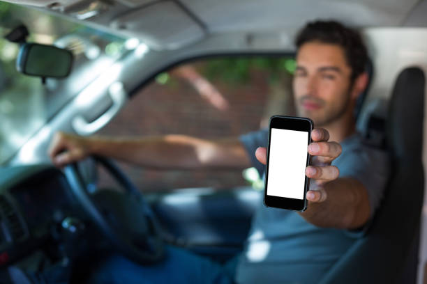 istock Driver holding phone in car 664633780