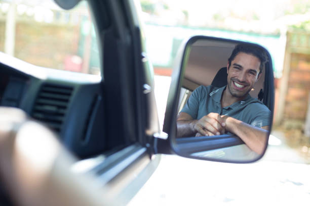 istock Handsome man sitting in car on mirror 664633812