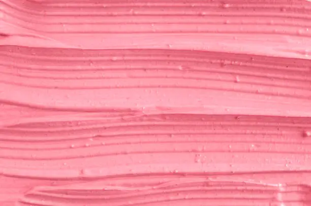Pink cosmetic clay (facial mask, cream) texture close up, selective focus. Abstract background