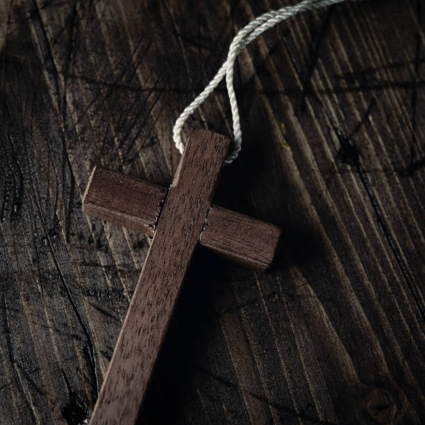 istock wooden cross with a cord 664639008