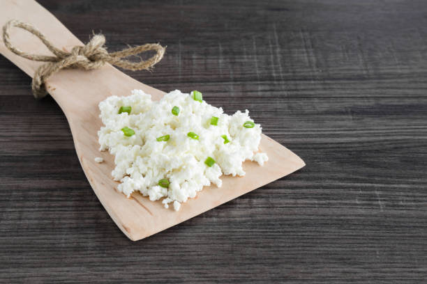istock Cottage cheese with spring green onions. Dairy product. Meal tasting. 664639384