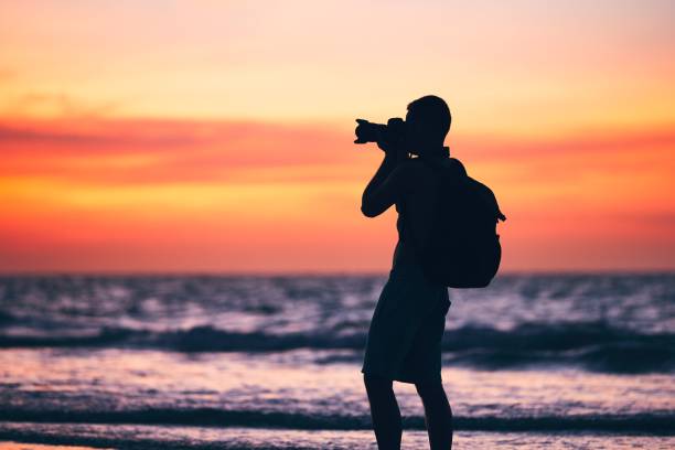 istock Photographer on the beach 664645358