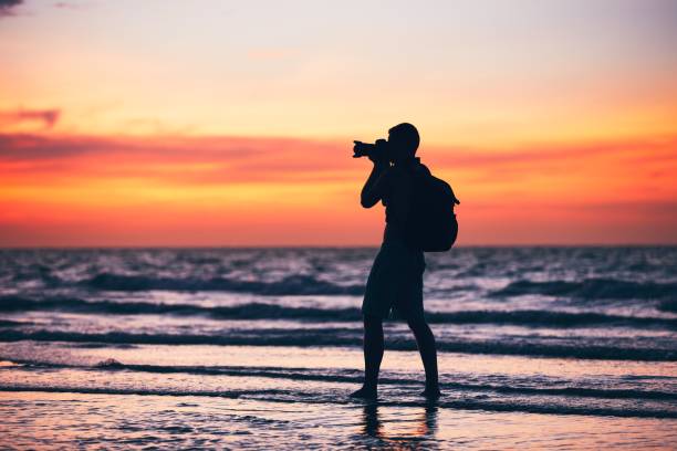 istock Photographer on the beach 664645758