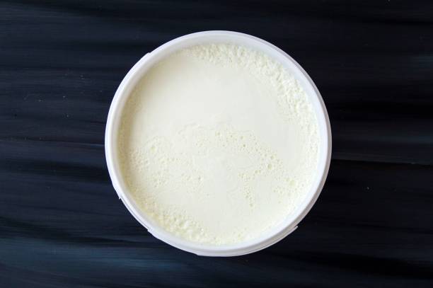 istock Yogurt in the bucket, yogurt fermented, yoghurt with spoon to take 664647240