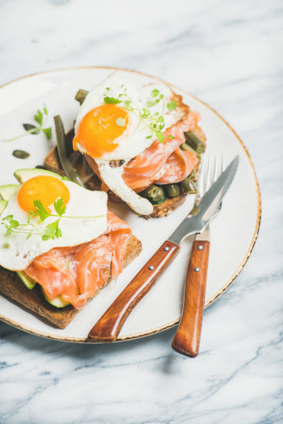 istock Healthy breakfast sandwiches in plate over marble background 664656546