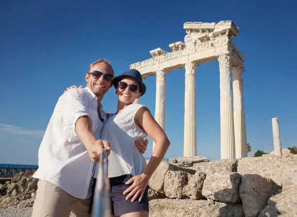 Photo of Smiling young couple take a selfie photo on antique ruins