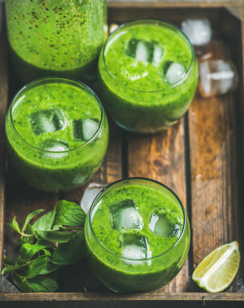 istock Fresh smoothie with ice cubes, mint, lime in wooden tray 664657860