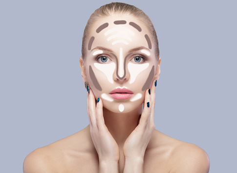 Contouring. Make up woman face on grey  background. Contour and highlight makeup. Professional face make-up sample
