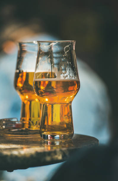 Two glasses of beer on a table in street cafe