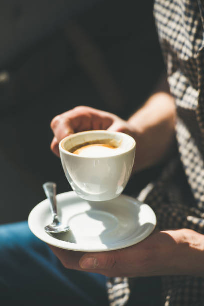 Cup of coffee cappuccino in man's hands