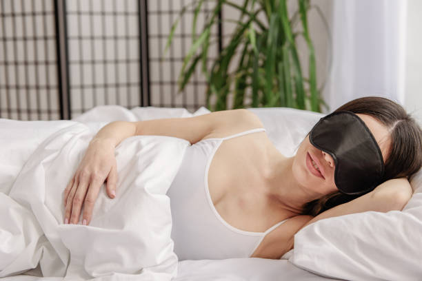 istock Happy asian woman lying in bed 664663892