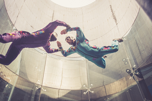 Indoor skydiving is the simulation of true freefall conditions in a vertical wind tunnel, Logatec, Slovenia, Europe. Copy space, No logo. Lens 24.0-70.0 mm f/2.8