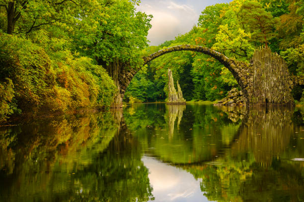 istock Autumn, cloudy evening over Devil's bridge in the park Kromlau, Germany 664667786