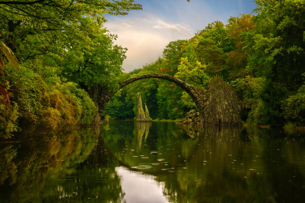 istock Autumn, cloudy evening over Devil's bridge in the park Kromlau, Germany 664668846