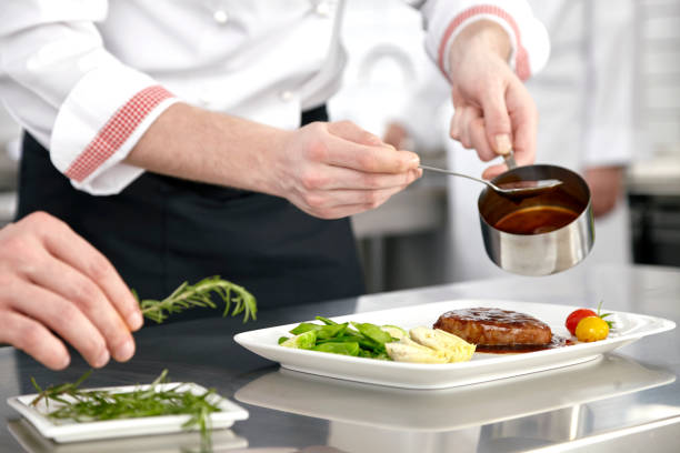 istock Male chef preparing steak plate 664672600