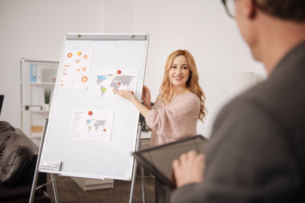 istock Delighted young office manager representing strategy project in the office 664673600