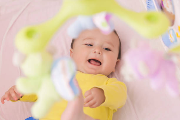 istock Happy baby lying in his crib smiling 664677508