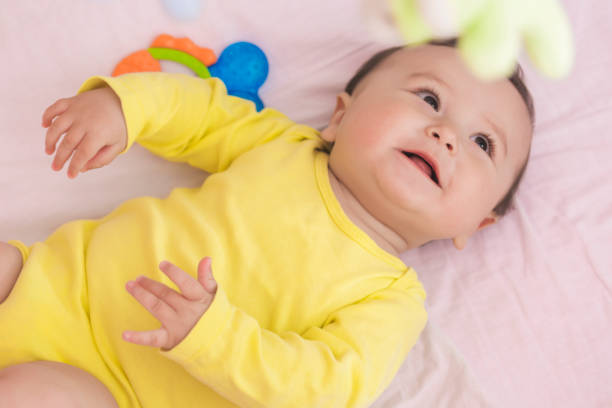 istock Playful baby lying in his crib smiling 664679754