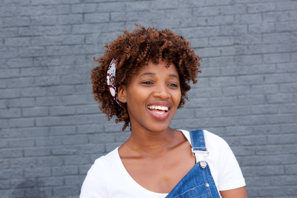istock african woman laughing against gray wall 664679920