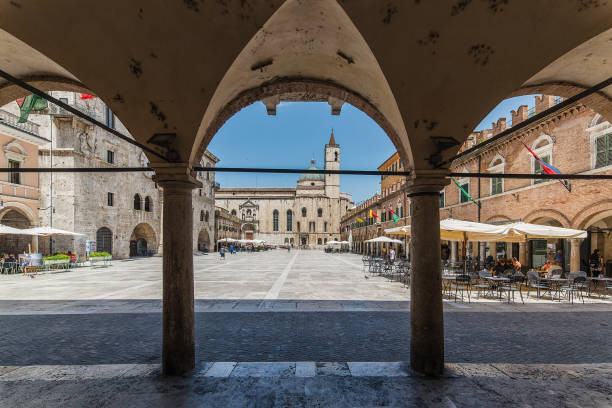 Ascoli Piceno,Church of San Francesco view from porches Ascoli Piceno, Italy - June 22, 2016. People walking on Piazza del Popolo. The square owes its name to the Palace of the Captains of the people built in the 13th century,view from porches marche italy photos stock pictures, royalty-free photos & images