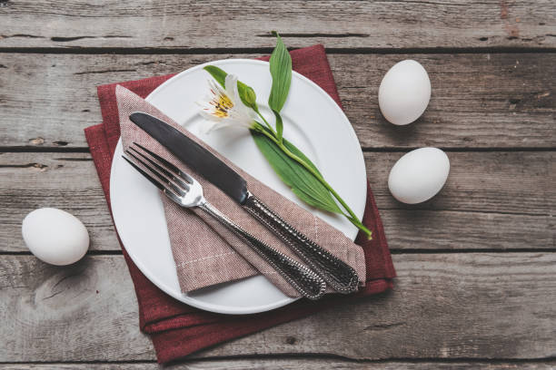 istock Top view of Easter table setting with cutlery, spring flower and Easter eggs on wooden table, Happy Easter concept 664687934