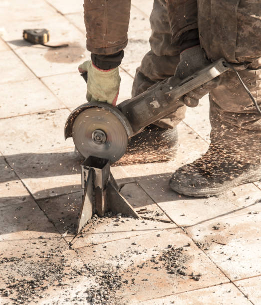 istock Worker cuts metal in the park 664688028