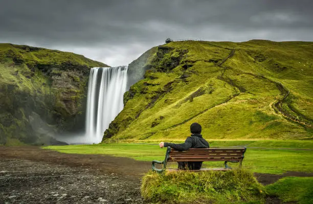 Photo of Hiker at the Skogafoss waterfall in southern Iceland