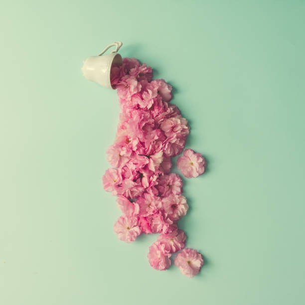 istock Creative layout made of coffee or tea cup with pink flowers. Flat lay. 664689998
