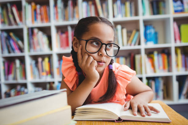 istock Little girl reading a book 664692162