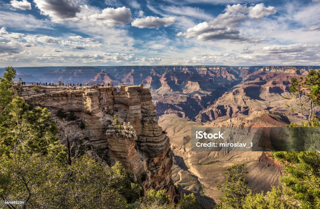 South rim of Grand Canyon from the "Mather Point" Tourists looking at  skyline scenery of Grand Canyon National Park from point of view named "Mather Point". Aerial View Stock Photo