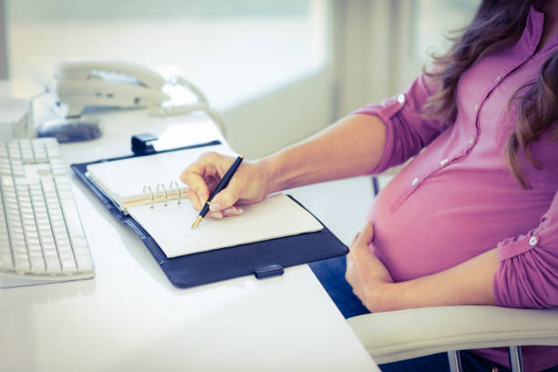 istock Midsection of businesswoman writing in diary 664692244