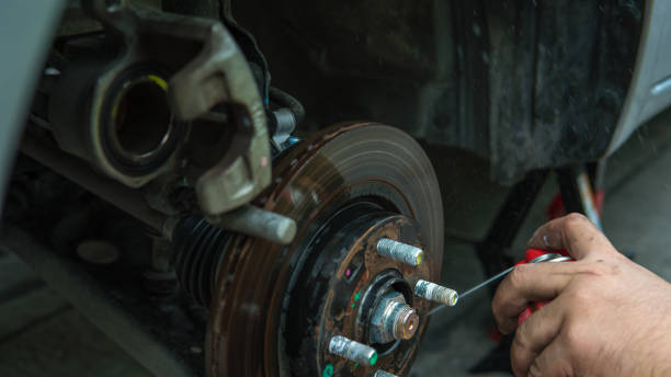 istock Close up mechanic repairing disk break with spraying oil 664695672