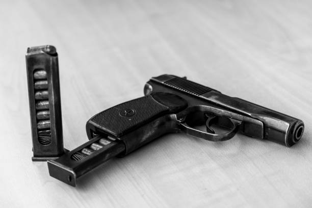 istock Military combat pistol in black and white 664696200