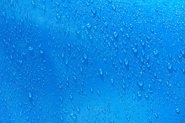 istock Water drops on blue metal background 664706944