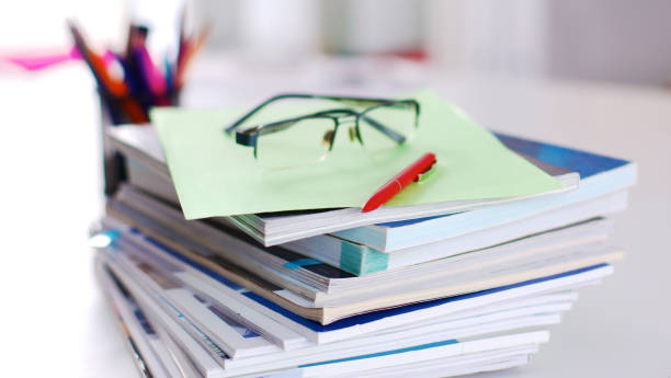 istock Group of multicolored office folders and glasses 664708128