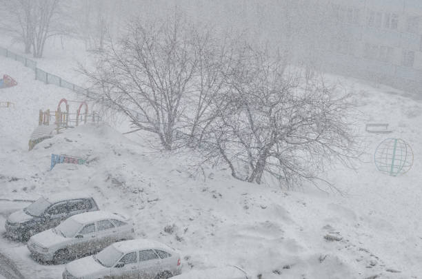 istock Cars in blur covered in snow on a parking 664708198