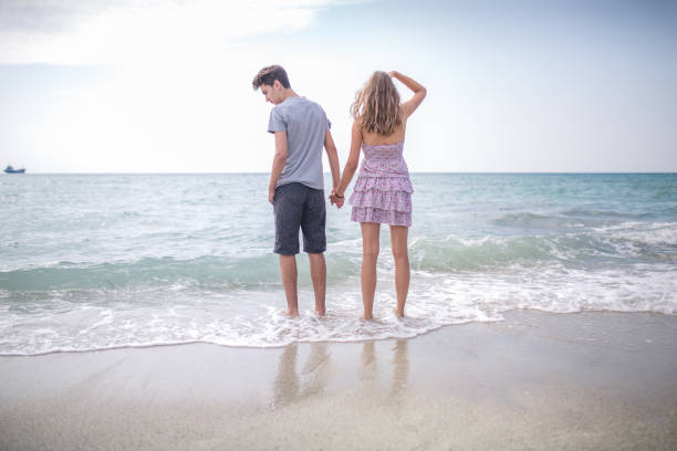 Two hearts intertwine on a perfect blue tropical beach