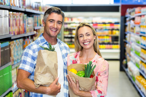 istock Smiling couple with grocery bags 664708344