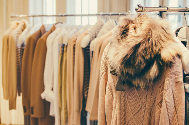 istock Women clothes on racks in a fancy store. 664708526
