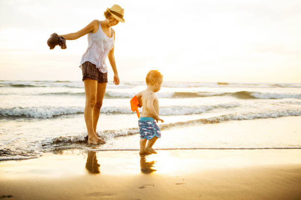 istock Mother and child playing on the beach 664709260
