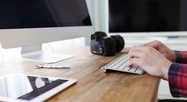 istock Photographer retouching working on photos and editing on desktop 664711492